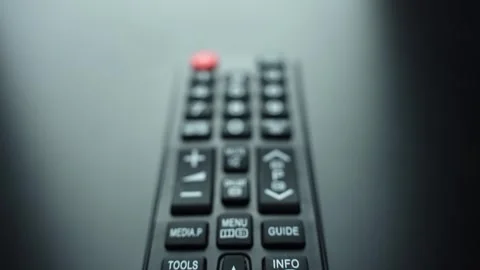 Macro close-up of TV remote numeric keypad with power button, shallow depth of Stock Footage 331107676