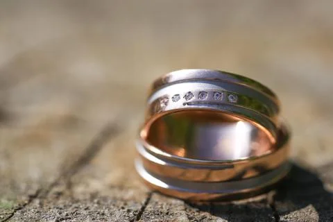 Macro close up of two wedding rings on wood Stock Photos