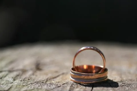 Macro close up of two wedding rings on wood Stock Photos