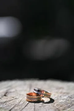 Macro close up of two wedding rings on wood Stock Photos