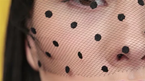 Macro close-up of a veiled face showcasing bright plum lips Stock Footage 311894445