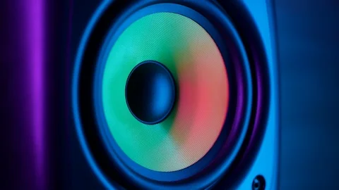 Macro close up of vibrating loud sound speaker in colorful neon lighting Stock Footage 105757768