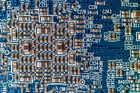 Macro close up view of a blue circuit board full of transistors Stock Photos