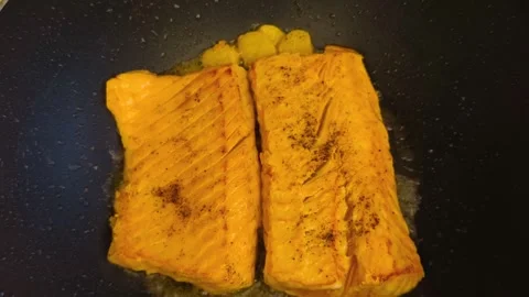 Macro close-up view of fresh hot sizzling fried salmon cooked in a dark fry.. Stock Footage 318254518