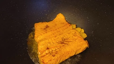 Macro close-up view of fresh hot sizzling fried salmon cooked in a dark fry.. Stock Footage 318254540