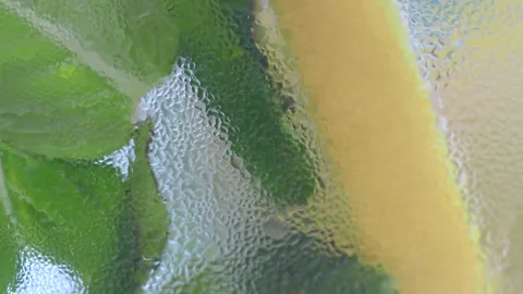 Macro close up view of refreshing cold water condensation on glass with lem.. Stock Footage 331914864