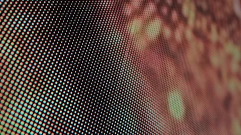 Macro close-up view of vibrant LED screen pixels in grid pattern, displaying Stock Footage 344095710
