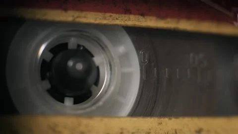 Macro Close Up Of Vintage Yellow Cassette Tape Reel Rotating Smoothly Video stock 329852933