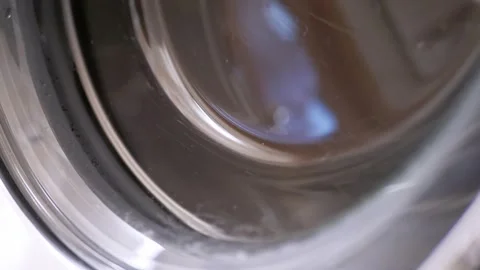 Macro Close Up of Washing Machine Glass Door with Smudges and Chrome Trim Stock Footage 338997084