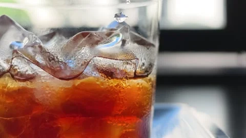 Macro Close-up of Water Droplet Falling Into Iced Cold Brew Coffee Stock Footage 344746817