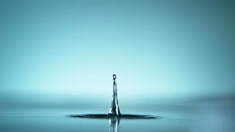 Macro Close Up of Water Droplets Falling Into a Calm Blue Liquid Surface Stock Footage 342110545