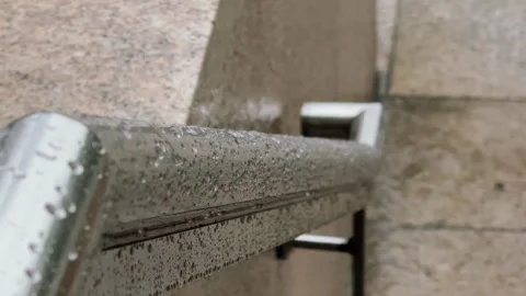 Macro Close Up of Wet Metal Railing handrail with Rain drops splashing. Danger 스톡 동영상 343477291