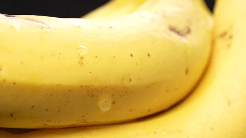 Macro Close Up Wet Ripe Yellow Banana Skin Texture Rotating 4K Stock Footage 322135089