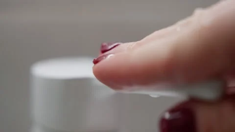 Macro close-up of a white liquid soap dispenser pump with a glistening droplet Stock Footage 317590568