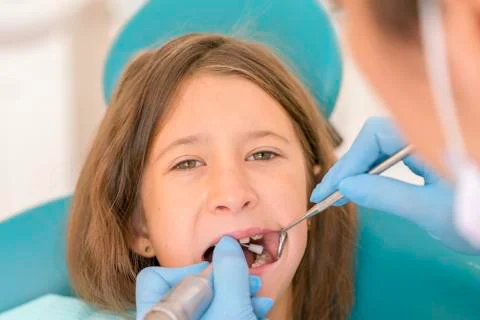 Macro close up of young child with open mouth at dentist. Teeth checkup at de Stock Photos
