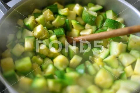 Macro close-up of zapallitos cut into pieces boiling in a pan Stock Photos