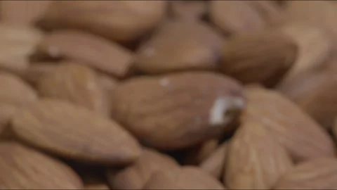 Macro close up zoom out shot of unshelled almonds on table Stock Footage 280338319