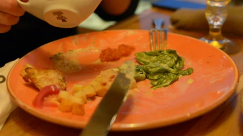 Macro closeup of caesar salad on plate with red tongs, parmesan cheese, dressing Stock Footage 97839964