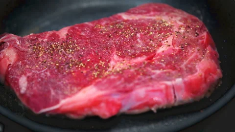 Macro closeup of cooking ribeye rib eye raw meat beef steak in home kitchen Stock Footage 154184161