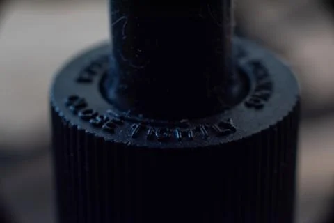 Macro closeup of a dropper cap full of hair and dirt Stock Photos