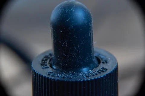 Macro closeup of a dropper cap full of hair and dirt Stock Photos