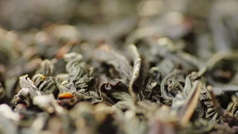 Macro closeup of dry green tea leaves texture rotating slowly as organic pr.. Stock Footage 334649850