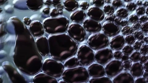 Macro closeup of an elements in water or oil, abstract background. 4K UHD Видео 63316638