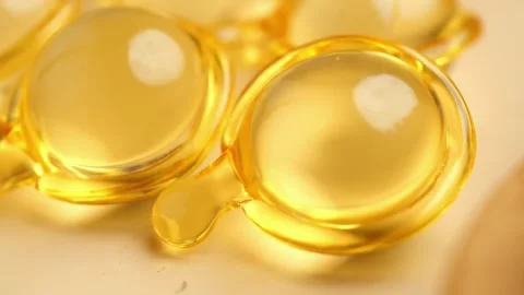 Macro closeup of golden liquid capsules for beauty and health treatments. Stock Footage 331725512