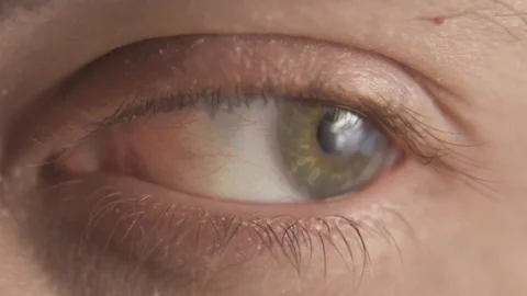 Macro closeup of a green human eye moving looking around Stock Footage 104604992