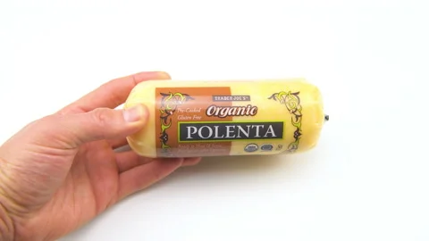 Macro closeup of hands holding cooked Italian corn polenta from Trader Joe's Stock Footage 218271419