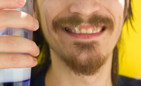 Macro closeup of lower half of man's face with thick white milk covering uppe Stock Photos