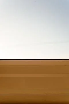 Macro closeup of a plastic window frame with a grey sky in the background. Co Stock Photos