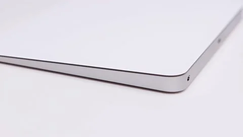 Macro closeup of rotating white Apple magic trackpad with large touch area Stock Footage 172480403