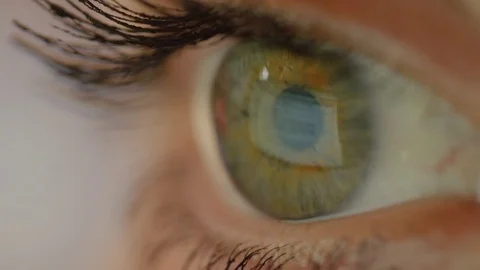 MACRO CLOSEUP Screen reflection on the surface of an eye when reading document Stock Footage 85198738