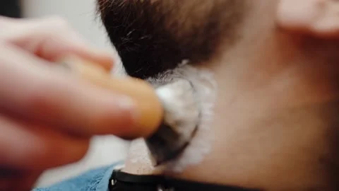 Macro closeup shot of the barber using lather brush to apply soap lather on the Stock Footage 210234037