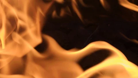Macro closeup slow motion: Flames bellow and surge and dance off dark backdrop Stock Footage 101265611