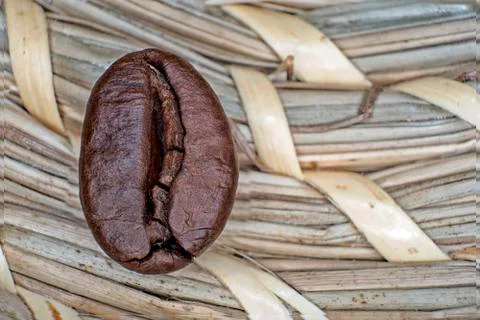 Macro coffee beans fried on a beige background Stock Photos