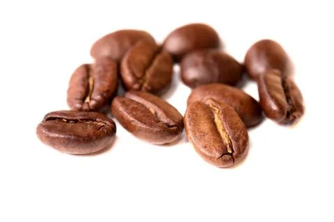 Macro of coffee beans on white background. Selective focus Stock Photos