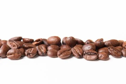 Macro of coffee beans on white background. Selective focus Stock Photos