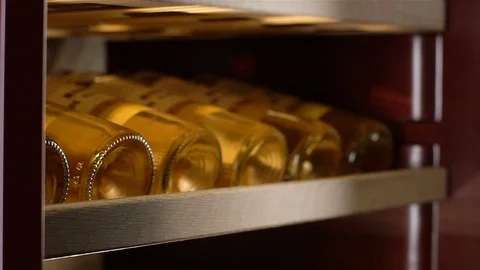 Macro Collection Wine Bottles Lie Bottom Forward in Cabinet Stock Footage 83281523