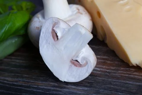 Macro composition of cooking ingredients, cheese, rosemary, basil leaves, and Stock Photos