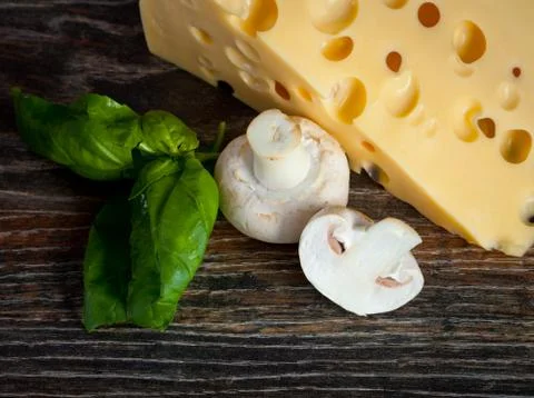 Macro composition of cooking ingredients, cheese, rosemary, basil leaves, and Stock Photos