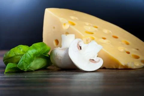 Macro composition of cooking ingredients, cheese, rosemary, basil leaves, and Stock Photos
