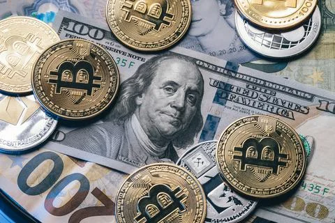Macro concept of dollar bill combined with group of golden crypto coins. Stock Photos