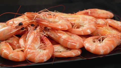 Macro of Cooked Vietnamese Whiteleg Shrimp Rotating on Black Plate Stock Footage 339634641