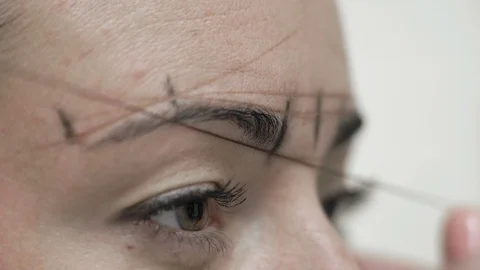 Macro Cosmetologist Draws Threads Around Client Eyebrows Stock Footage 96998530