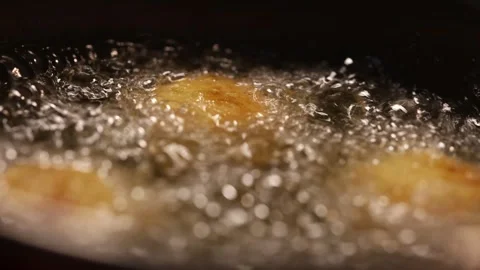 Macro of croquettes frying in a pan with boiling oil Stock Footage 320351810