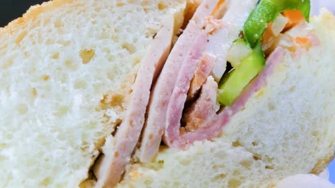 Macro cross section of fresh Vietnamese banh mi sandwich with ham Stock Footage 340254376
