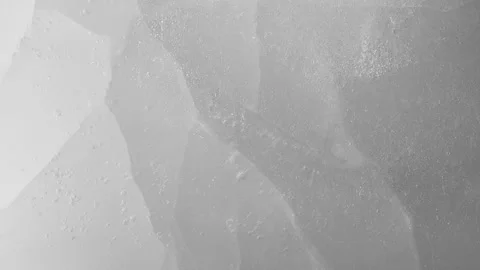 Macro crushed ice texture with splashing water surface, water drops and ripples Stock Footage 234259966