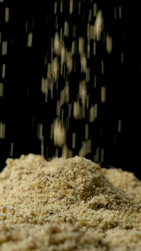 Macro crushed walnut kernels pour vertical slow motion Stock Footage 327149296